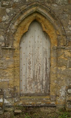 The badly eroded 'blocked up' north facing trefoil shaped door(also 13th century?)