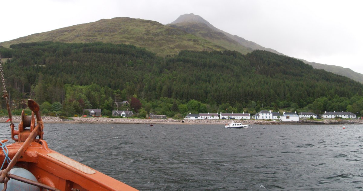 Boat trip to Inverie main village of the Knoydart Peninsula, towering above is Sgurr Coire Choinnichean mountain forming an impressive backdrop.