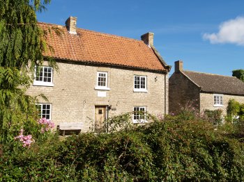 Cold Kirby is essentially a one, wide street village with a number of attractive stone houses, most of which have a lovely flower garden - Walking from Sutton Bank National Park Visitor Centre, North York Moors National Park, North Yorkshire, Northern England