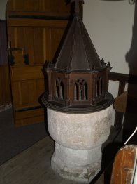 The original Norman stone font and wooden cover of St Michael's Church, Cold Kirby Village - Walking from Sutton Bank National Park Visitor Centre, North York Moors National Park, North Yorkshire, Northern England
