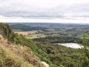 After passing by Whitestone Cliff you get the first views of the glacial in origin, Lake Gormire - Walking from Sutton Bank National Park Visitor Centre, North York Moors National Park, North Yorkshire, Northern England