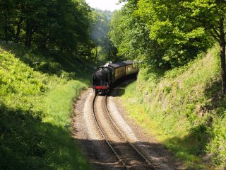 The North Yorkshire Moors steam railway, train approaching the road bridge above Beck Hole