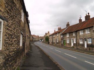 the Scarborough Road which passes up through rows of old houses, Thornton-le-Dale, North Yorkshire, England