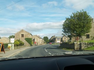 Driving through Aysgarth Village on the A684 Leyburn to Hawes road, Yorkshire Dales National Park, North Yorkshire, England