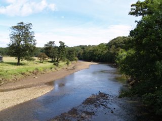 The River Esk downstream from the road bridge - Ruswarp on the River Esk near Whitby, North Yorkshire, Northern England