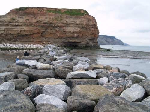The north-east cliff head and the massive breakwater of huge boulders.