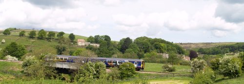 The train passing over the River Esk near Danby Lodge, a North Yorkshire Moors National Park Centre (right).