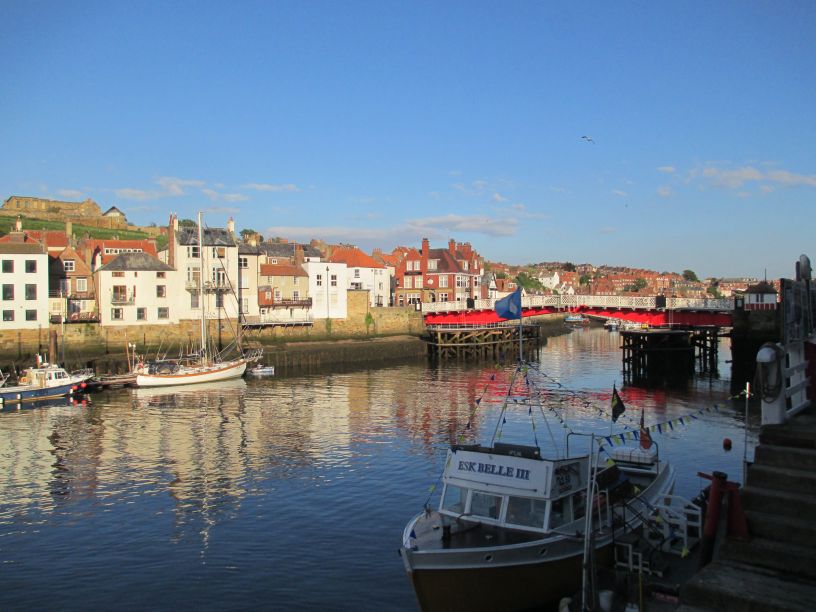 The red painted swing bridge, Whitby Harbour, on the right is the ESK BELLE III tourist boat which takes holidaymakers on a trip out to sea.
