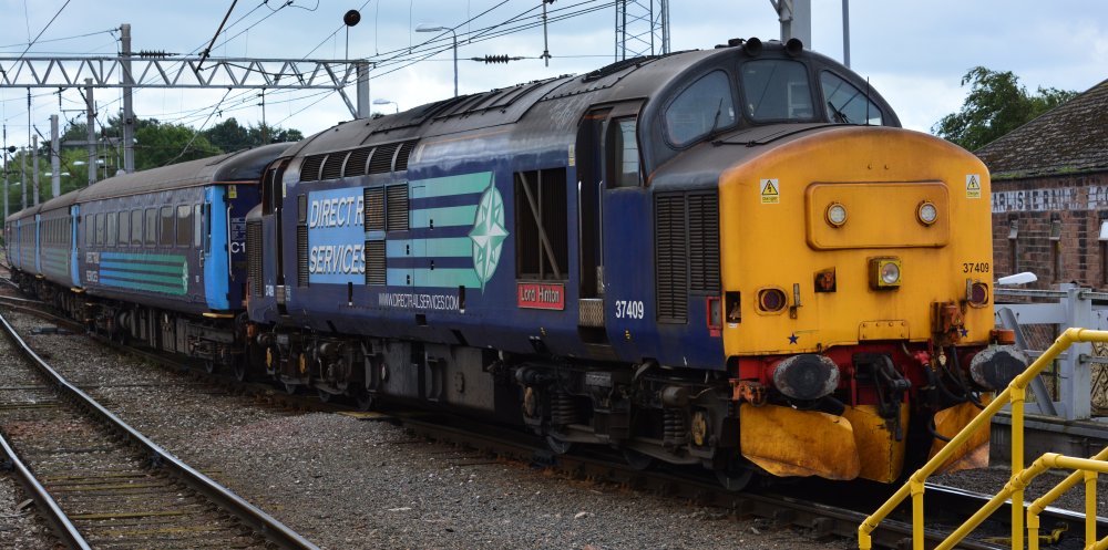 DRS Class 37 diesel locomotive 37409 Lord Hinton entering Carlisle station with a 'Northern Rail' service from Barrow on the Cumbrian Coast Line entered service in 1965 as D6970 and has also carried the number 37270