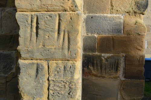 sharpening arrow heads deep grooved carvings in porch of St Mary's Church, Thirsk, purpose?