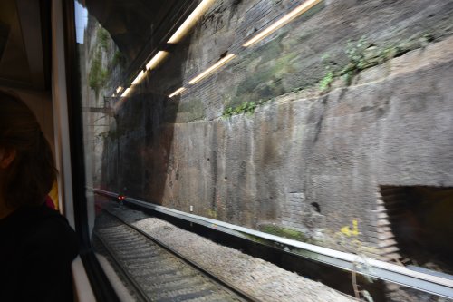 View from the train of a section of the stone cutting as the railway approaches Liverpool Lime Street Station.