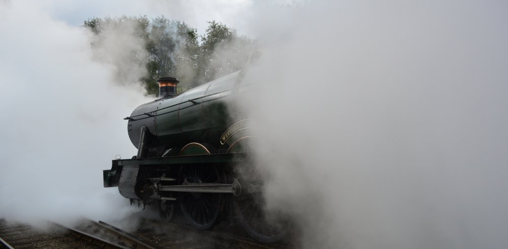 Passenger train leaving Grosmont station NYMR 6990 Witherslack Hall GWR Modified Hall steam locomotive
