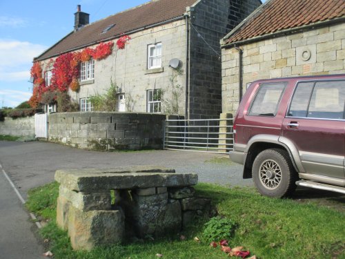 An 'old' milk churn stand on a roadside farm in Ainthorpe, North Yorkshire