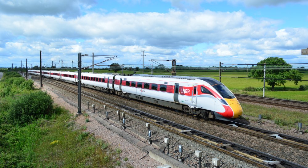 Class 801 EMU 801220 with the 0830 LNER Azuma service from London Kings Cross to Edinburgh trainspotting Colton Junction footbridge