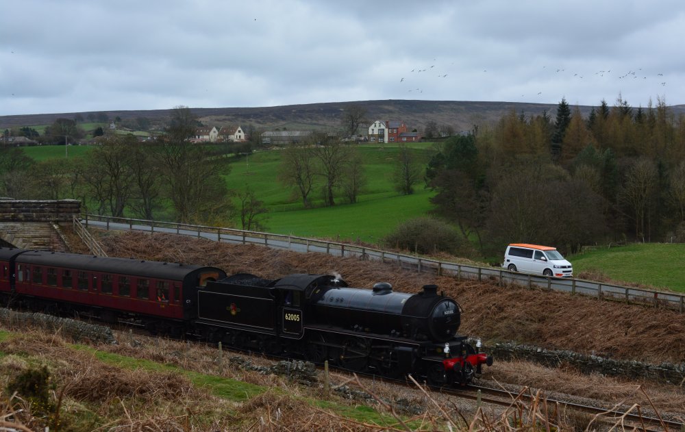 Steam train on the Esk valley Line passing Ainthorpe village in the background, North Yorkshire, England