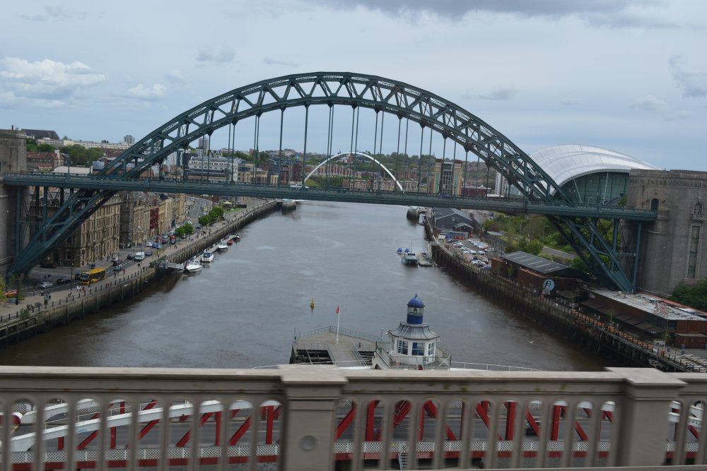 The Tyne Bridge viewed from the railway train travelling over the High Level Bridge from Gateshead to Newcastle-upon-Tyne