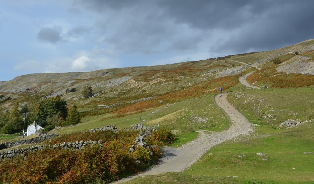 The stone track from High Fremington to Fremington Edge, the White House on the left North Yorkshire Dales National Park England