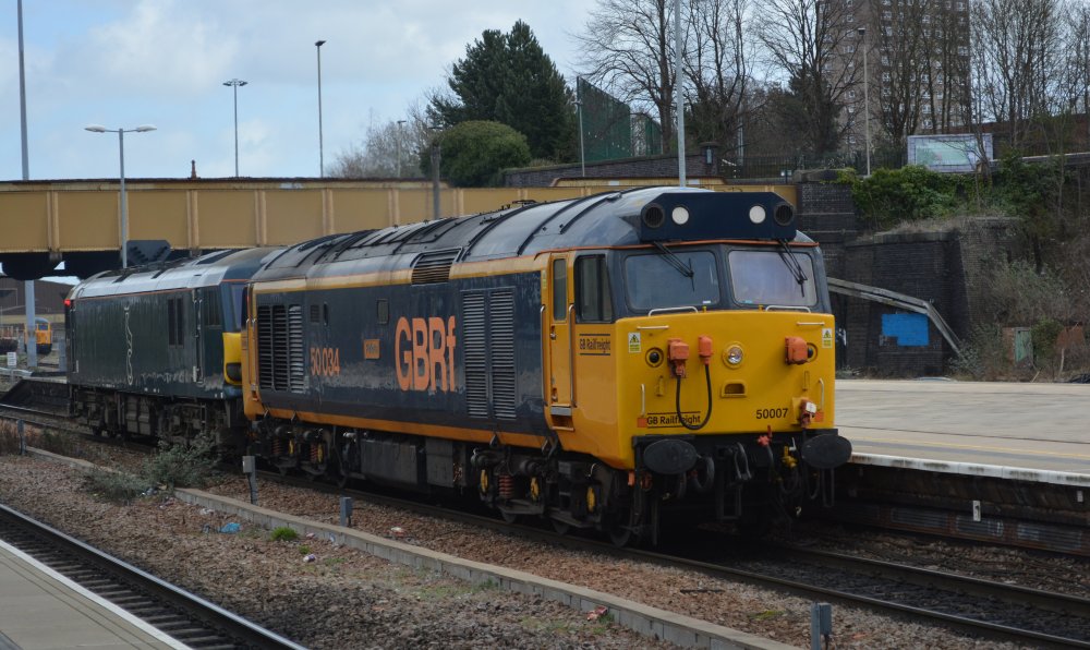 Class 92 electric locomotive hauled SE through Leicester station  by a Class 50 diesel locomotive displaying numbers 50007 and a temporary designation of 50034 (Trainspotting March 2023).