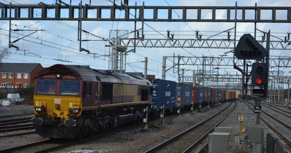 Trainspotting an ex EWS Class 66 diesel freight locomotive heading south through Nuneaton station with an inter-modal freight train from the Midlands