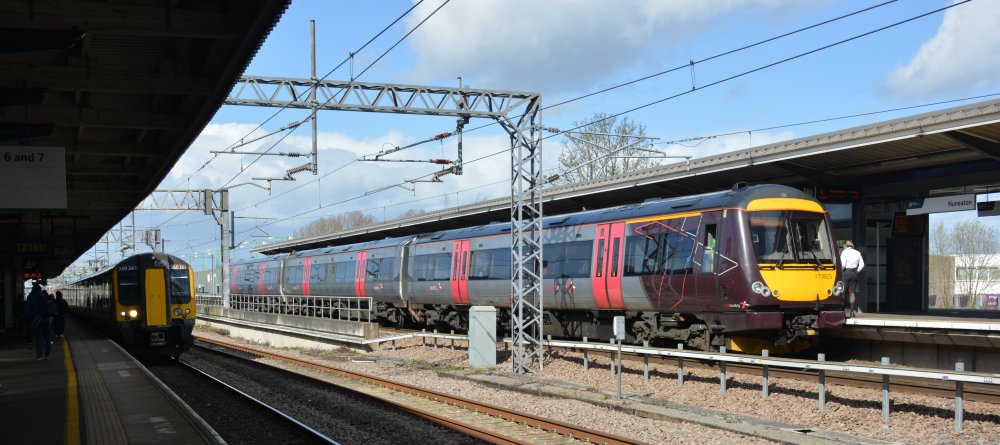 A Class 170 DMU unit at platform 6 Nuneaton station with a CrossCountry service from Stansted Airport to Birmingham New Street (Trainspotting, March 2023), On the left, stopped at platform 5, a Class 350 EMU on an LNWR service from Crewe to London Euston.