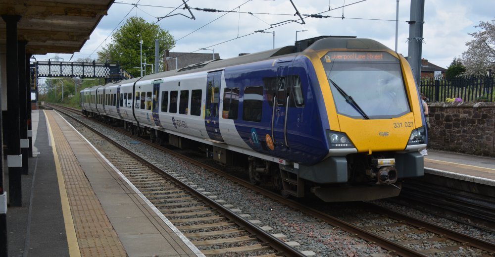 A CAF built Class 331 EMU 4-car unit 331017 At Rainhill station with a Northern Rail Service from Manchester Airport to Liverpool Limes Street station.