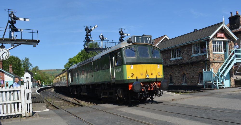 Class 26 diesel locomotive D7628 SYBILLA still going strong at Grosmont station and departing with train to Pickering (NYMR, May 2024)