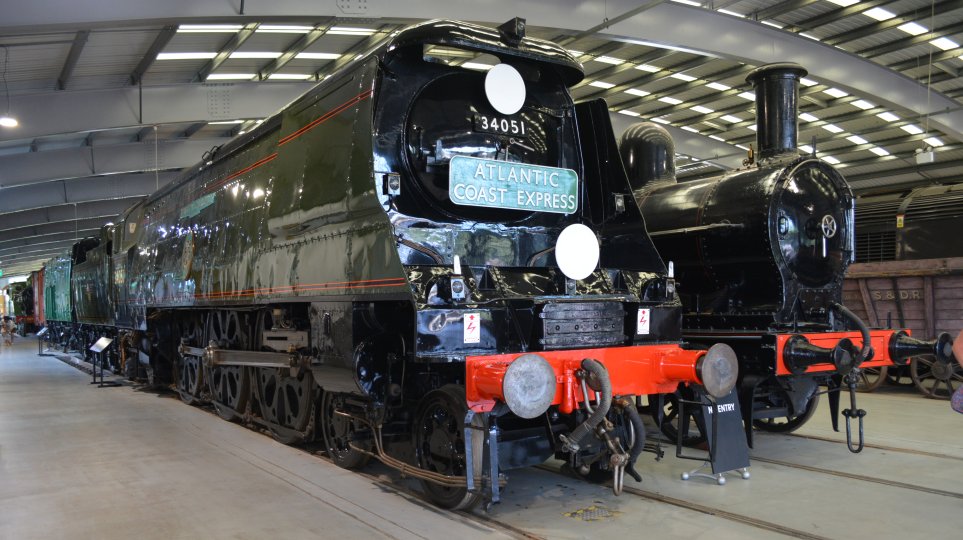 Carrying the ATLANTIC COAST EXPRESS headboard, un-rebuilt Battle of Britain Class steam locomotive 34051 WINSTON CHURCHILL  in Shildon NRM