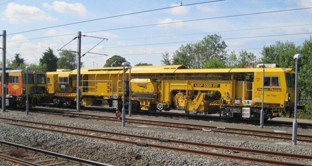 Network Rail Plasser & Theurer ballast distribution and profiling track machine  DR 77907 USP 5000 RT (Nuneaton station, 2024)